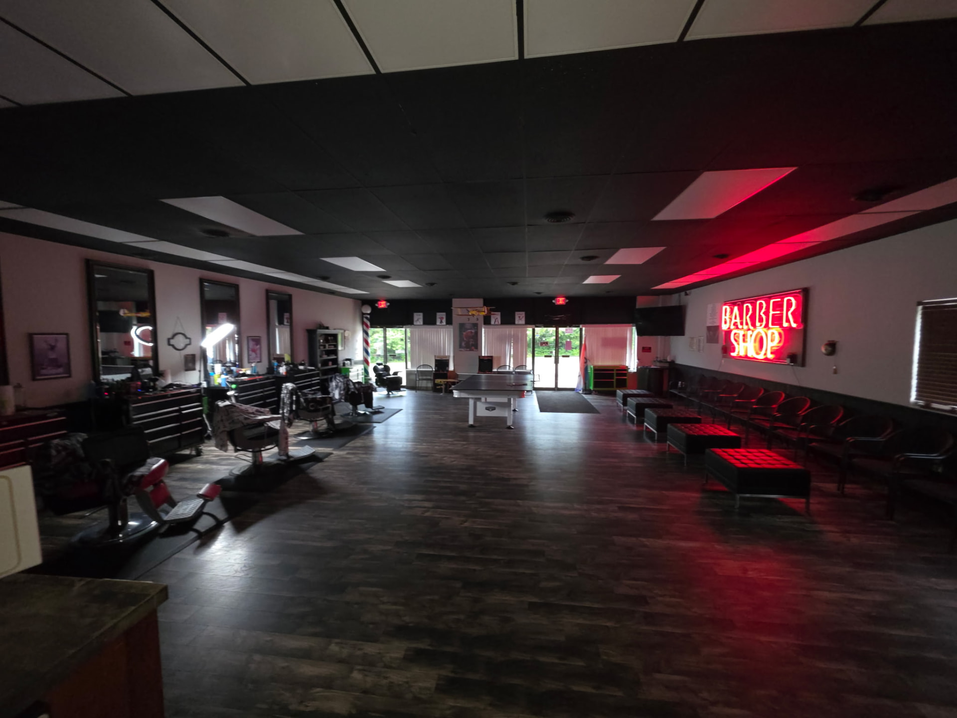 Inside RT8 Barbers, with barber chairs and a neon barber shop sign